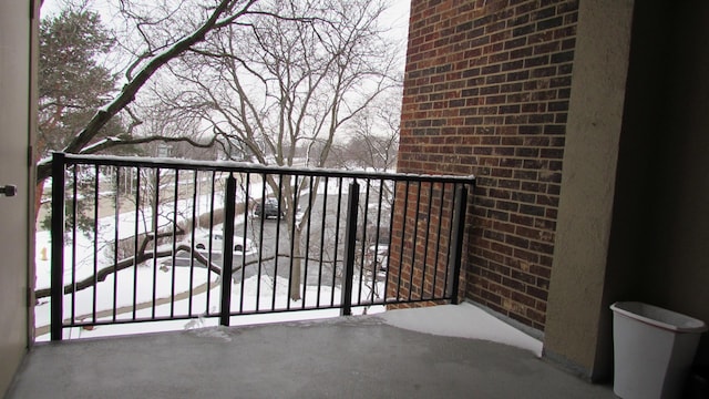 view of snow covered back of property