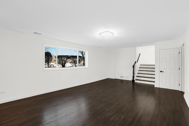 empty room with dark hardwood / wood-style flooring