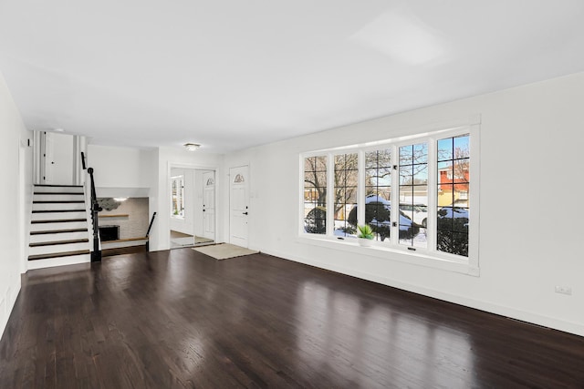 unfurnished living room with a fireplace and hardwood / wood-style flooring