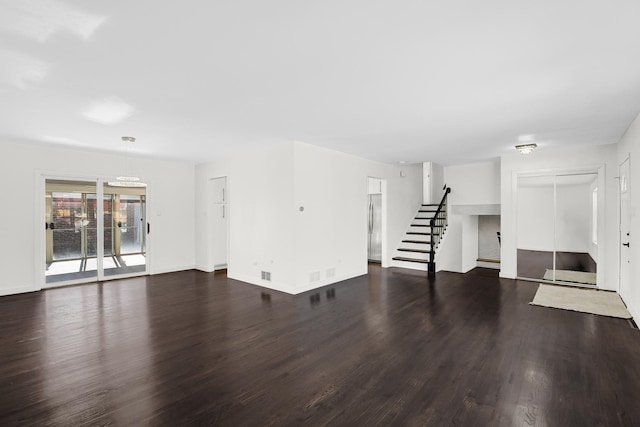 unfurnished living room with dark hardwood / wood-style floors