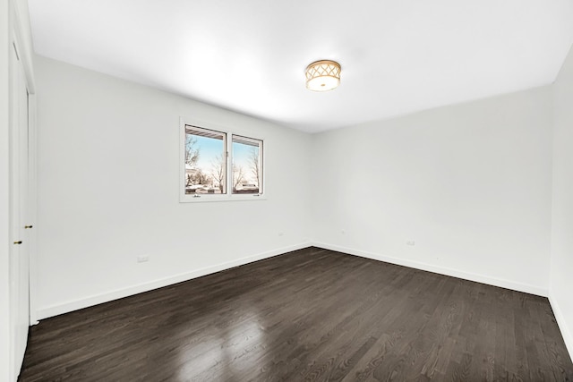 empty room with dark hardwood / wood-style floors