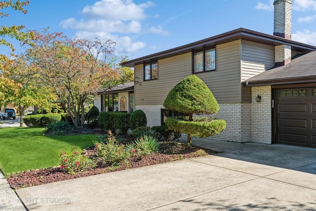 view of side of property with a garage and a yard