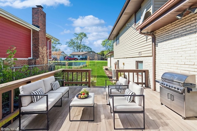 wooden deck with area for grilling and an outdoor hangout area