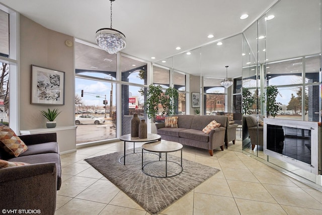 tiled living area featuring expansive windows, a notable chandelier, and recessed lighting