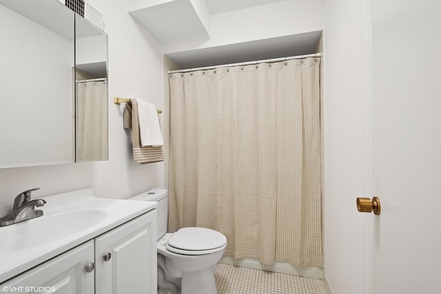 bathroom with toilet, tile patterned flooring, and vanity