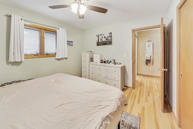 bedroom with ceiling fan and light hardwood / wood-style floors