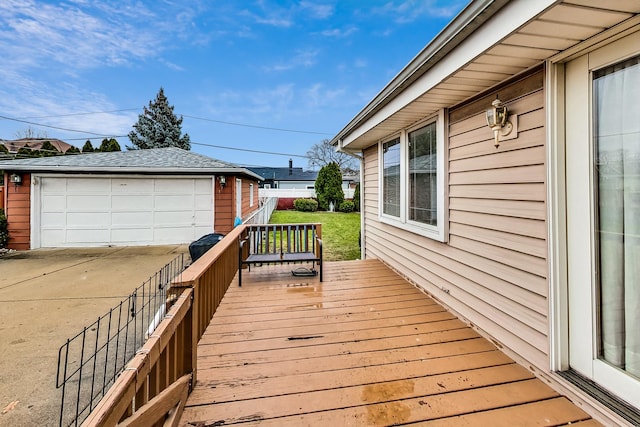 deck featuring a garage and an outdoor structure