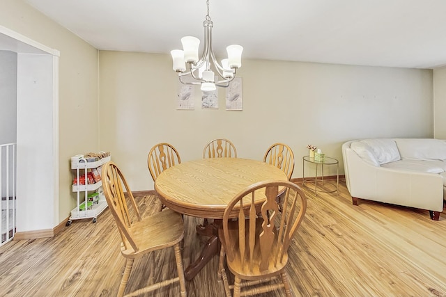 dining space featuring a chandelier and light wood-type flooring