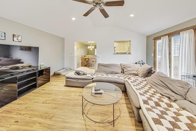 living room featuring vaulted ceiling, ceiling fan, and light hardwood / wood-style flooring