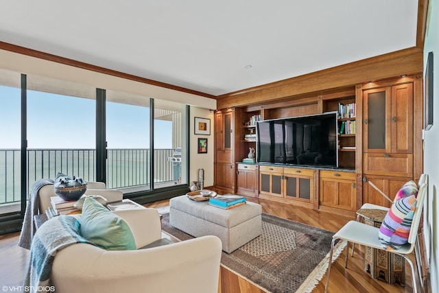 living room with crown molding, hardwood / wood-style flooring, and a water view