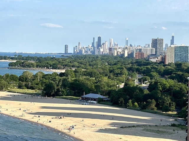 property's view of city with a water view and a beach view