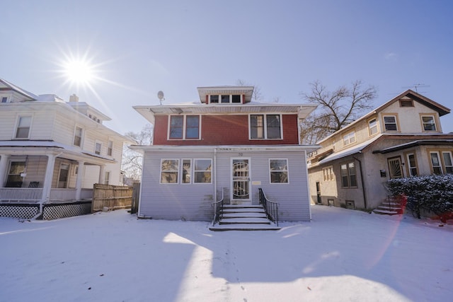 view of snow covered rear of property