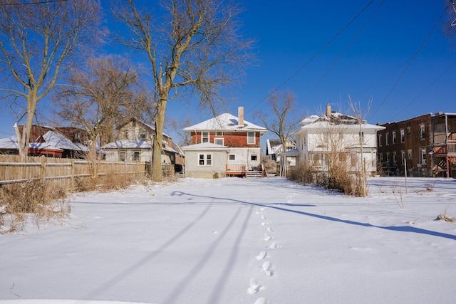 view of snow covered rear of property