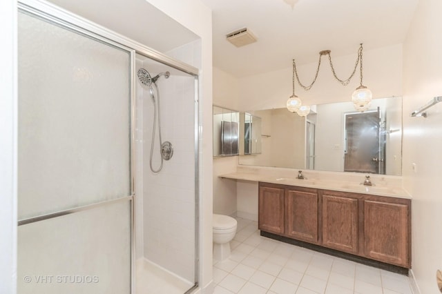 full bath with a sink, a shower stall, toilet, and double vanity