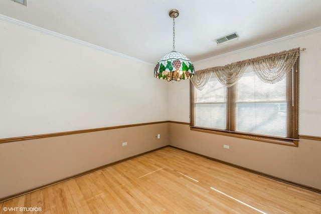 unfurnished room featuring crown molding and wood-type flooring