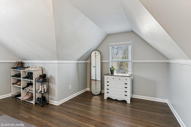 additional living space with lofted ceiling, dark wood-type flooring, and baseboards