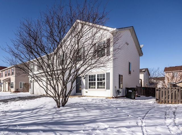 view of front of house with a garage and fence