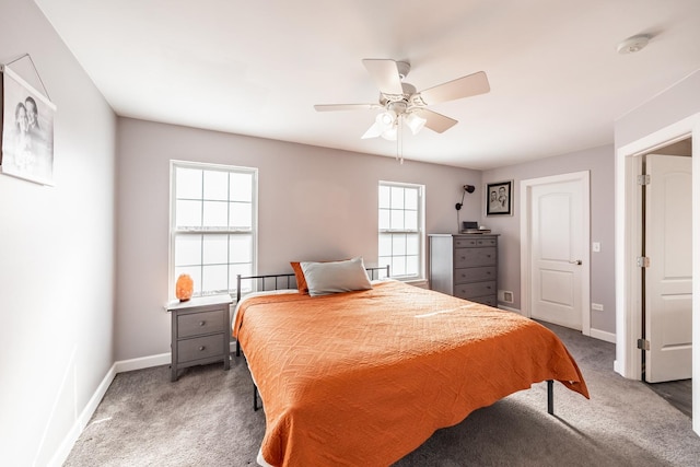 bedroom featuring a ceiling fan, dark colored carpet, and baseboards