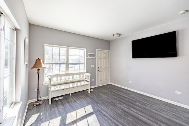 entrance foyer featuring baseboards and dark wood finished floors