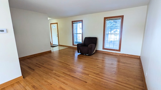 unfurnished room with light wood-style floors and baseboards