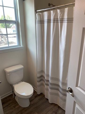 486 Ridge Ln, Bolingbrook, IL 60440 - bathroom with hardwood / wood-style flooring, a shower with shower curtain, and toilet