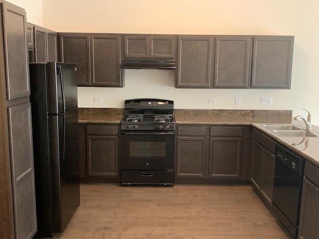 486 Ridge Ln, Bolingbrook, IL 60440 - kitchen with dark brown cabinets, sink, light hardwood / wood-style flooring, and black appliances