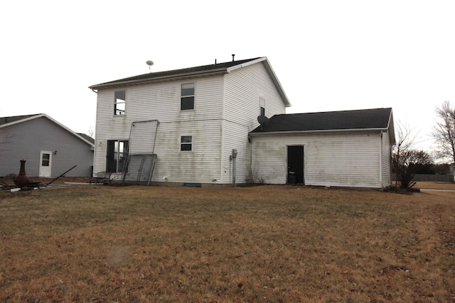 rear view of house featuring a lawn