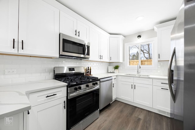 kitchen featuring appliances with stainless steel finishes, sink, and white cabinets