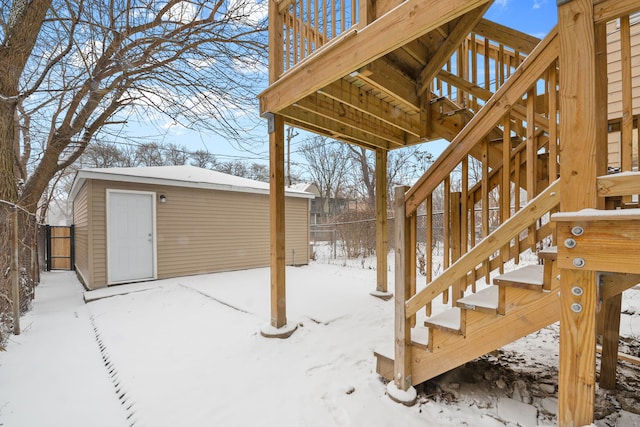 yard layered in snow featuring an outbuilding