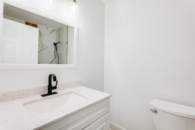 bathroom featuring vanity, toilet, and a marble finish shower