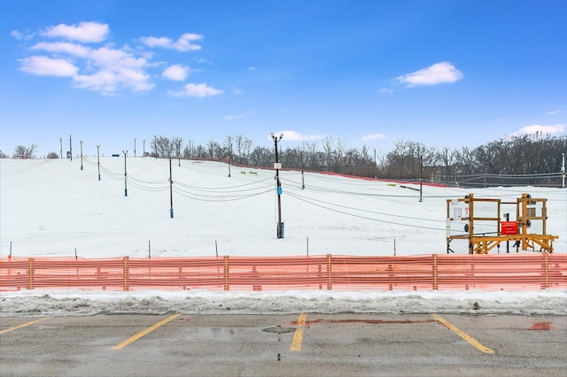 surrounding community featuring fence and uncovered parking