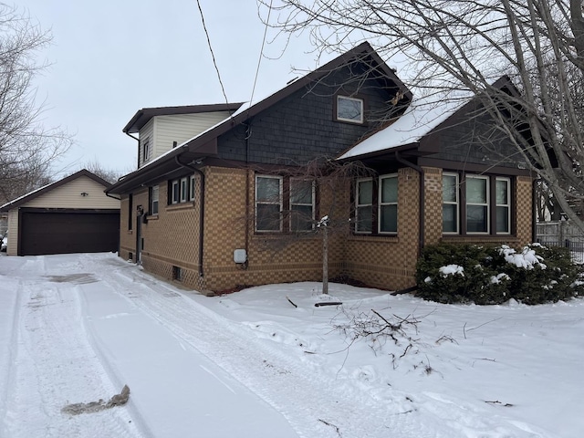 view of front of home with a garage and an outdoor structure