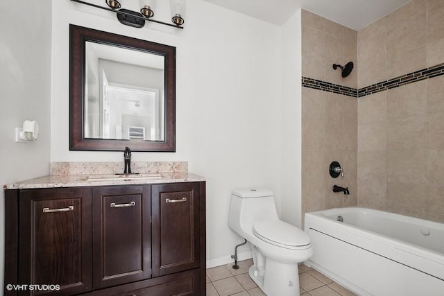 full bathroom with tile patterned flooring, vanity, tiled shower / bath combo, and toilet