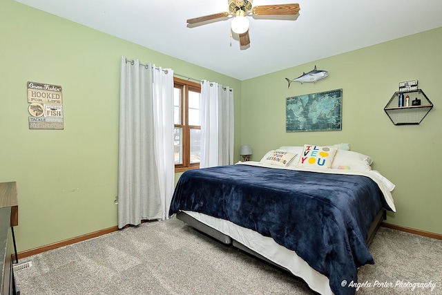 carpeted bedroom featuring baseboards and a ceiling fan