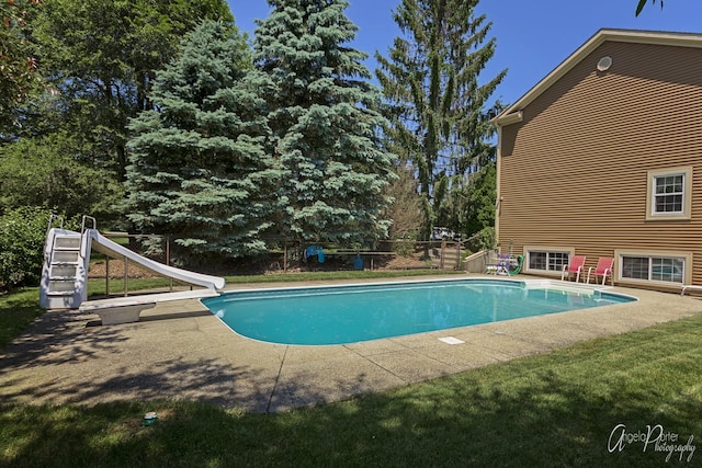 outdoor pool featuring a water slide