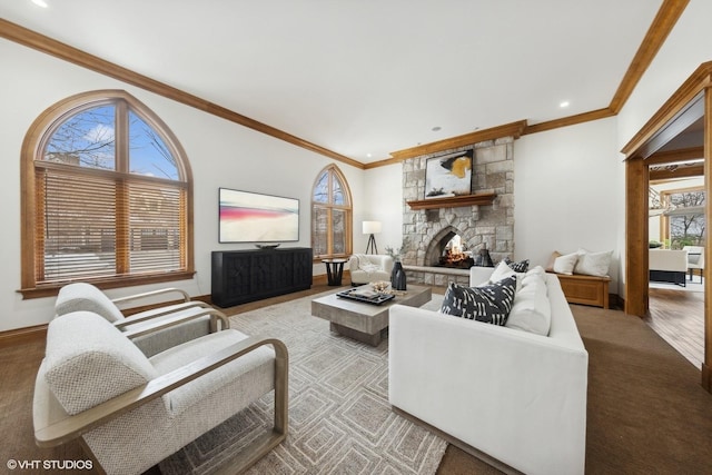 living room featuring a stone fireplace, ornamental molding, and light hardwood / wood-style floors