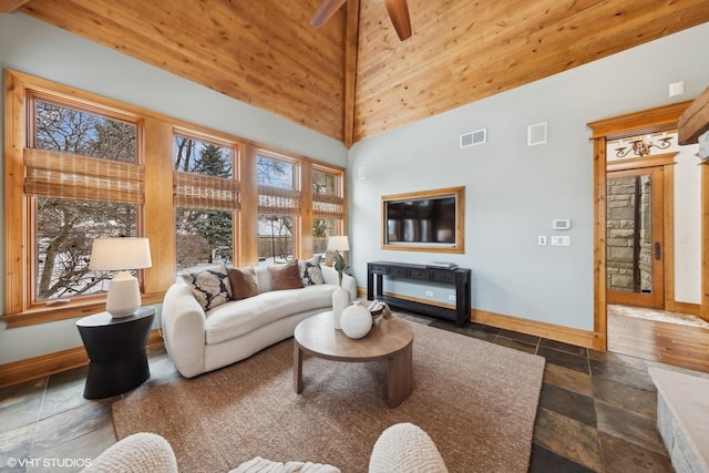 living room featuring ceiling fan and a high ceiling