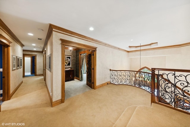 corridor featuring ornamental molding and light carpet