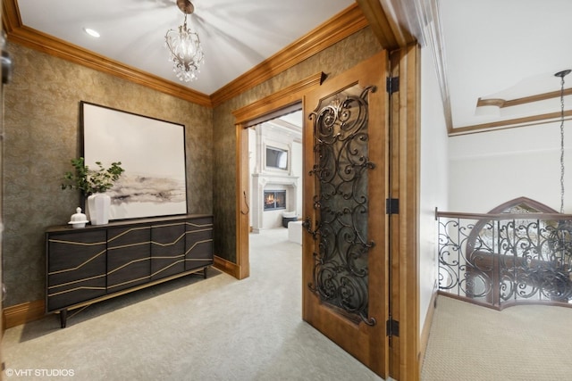 hall featuring crown molding, light colored carpet, and a chandelier