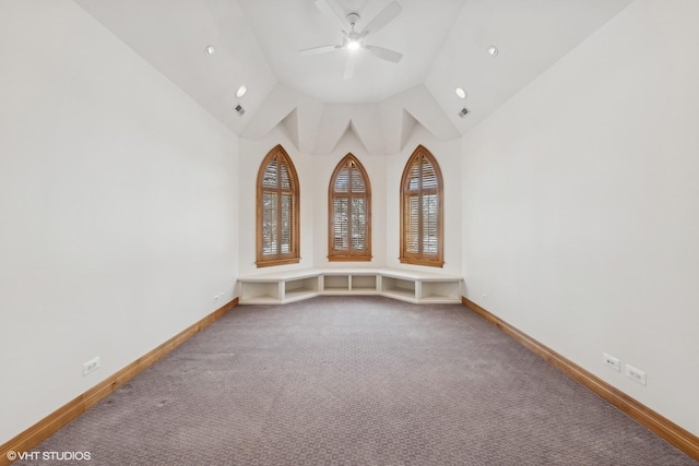 spare room featuring vaulted ceiling, ceiling fan, and carpet flooring