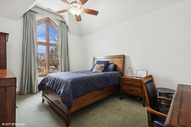 carpeted bedroom featuring ceiling fan, vaulted ceiling, and multiple windows