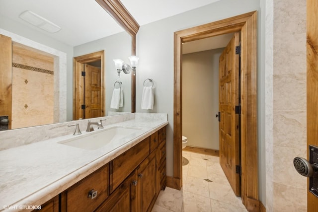 bathroom featuring tile patterned flooring, vanity, and toilet