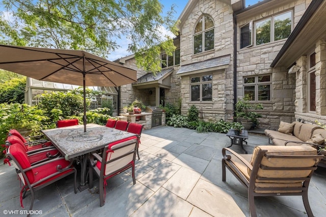 view of patio with area for grilling and outdoor lounge area