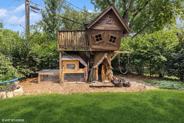 view of playground with an outbuilding and a yard