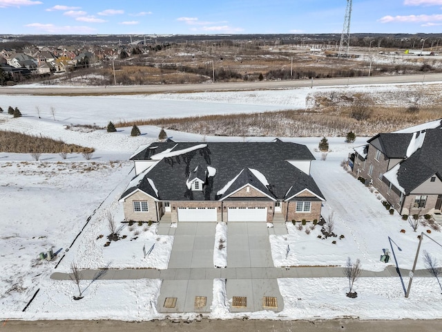 snowy aerial view with a residential view