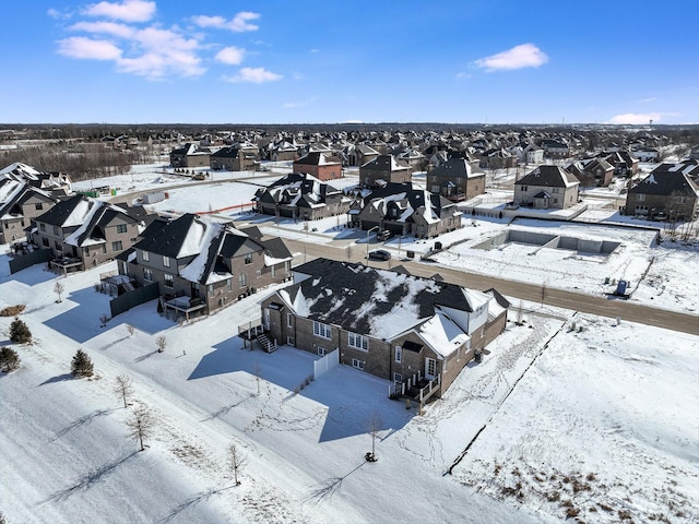 snowy aerial view featuring a residential view