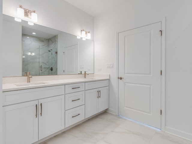 bathroom featuring double vanity, marble finish floor, a marble finish shower, and a sink