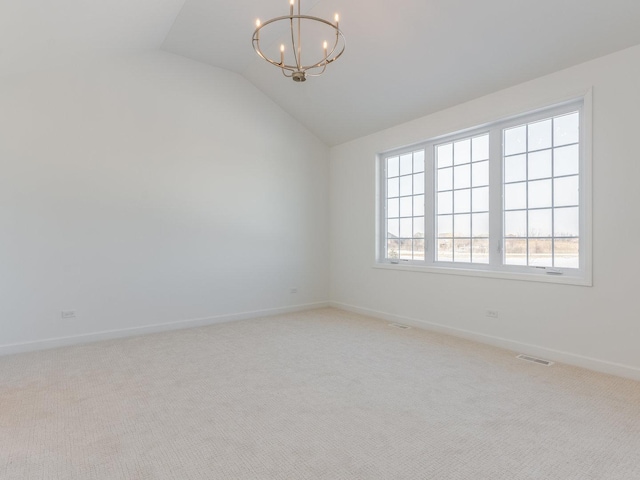 empty room featuring vaulted ceiling, light colored carpet, visible vents, and an inviting chandelier