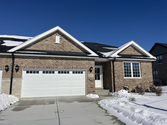 view of front of home featuring brick siding, driveway, and an attached garage