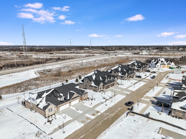 snowy aerial view featuring a residential view